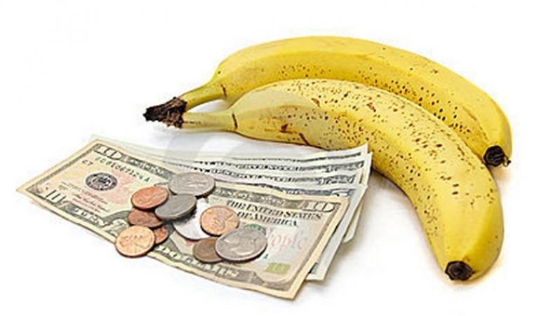 Two bananas with a pile of money