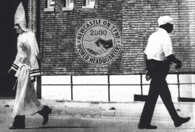 KKK member walking away from another man