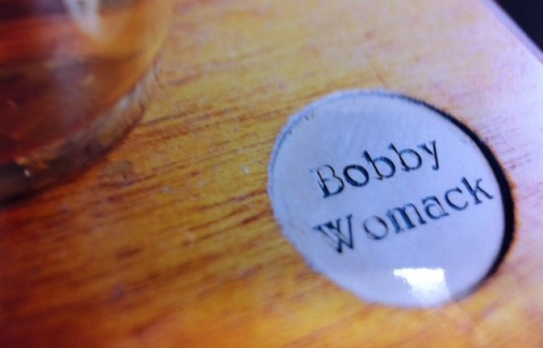 Wood with "Bobby Womack" engraved on it