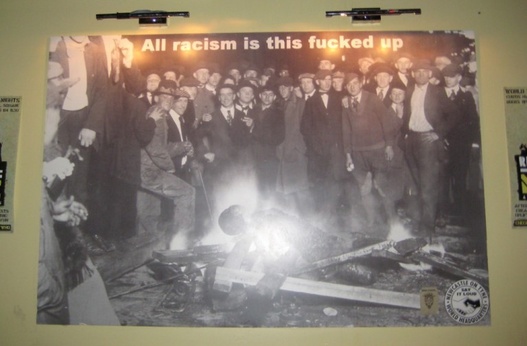 Poster of a lynching with the words 'All racism is this fucked up'